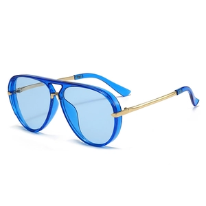 Detail of aviator sunglasses featuring transparent blue resin frames and gold metal temples