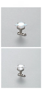 Close-up of 6mm square zircon dermal anchor studs with iridescent and clear stones