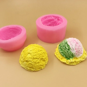 Pink silicone ice cream molds with finished scoops on a clean flat background