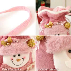 Pink plush Christmas gift bag with a 3D snowman, drawstring closure, and sturdy handle