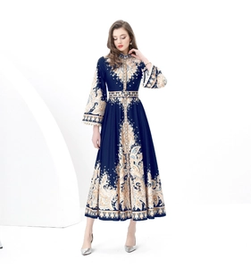 Detail of high-neck paisley printed dress with long sleeves and matching belt