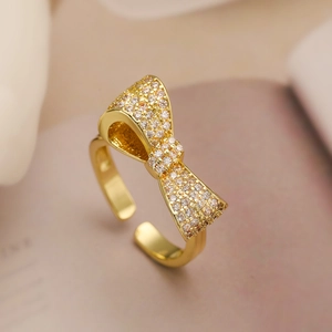 Detailed view of an 18K gold plated bow ring featuring sparkling zircon micro-pave setting
