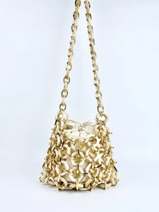 Detail of acrylic hexagonal link cage with beige canvas drawstring inner bucket bag