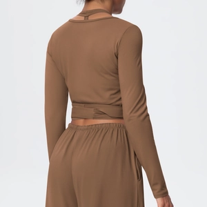 Deep brown yoga set featuring a back view of the wrap-around long sleeve top and joggers
