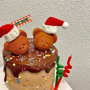 Christmas bear cake toppers with red knitted hats and chocolate glaze decoration