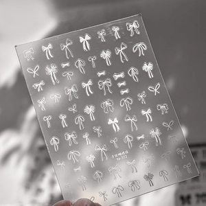 Macro detail of ta-372 nail art sticker featuring delicate hand-drawn white bows