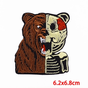 Macro detail of half bear half skeleton embroidered patch with 6.2x6.8cm size mark