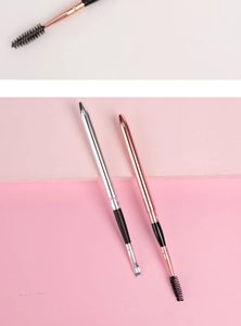 Dual-ended eyebrow and eyelash brush tool with metallic handles in a macro detail view