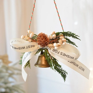Christmas pine cone hanging ornament with golden bells and green pine branches