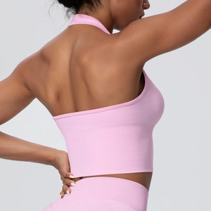 Detail of pink seamless ribbed sports bra featuring a cross halter open back design