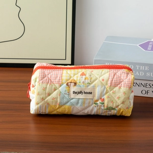 Detailed close-up of quilted cotton pencil case with yellow checkered pattern and red zipper