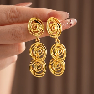 Detailed view of vintage gold-plated spiral earrings with elegant metallic texture