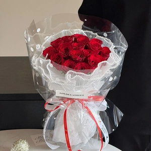 Red rose bouquet wrapped in snowflake cellophane with pearl lace for Christmas gifting