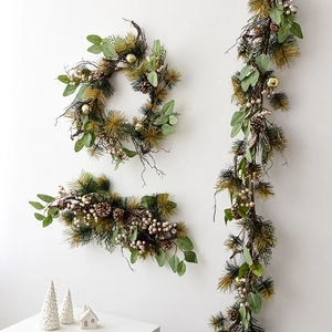 Christmas garland with pine needles, eucalyptus leaves, pine cones and festive berries