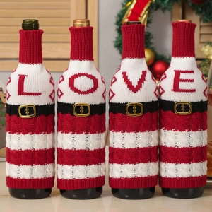 Set of 4 festive knitted Christmas wine bottle covers with LOVE letters on holiday table