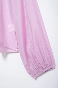 Detail of pink semi-transparent chiffon fabric with pleated texture and elastic cuffs