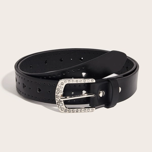 Vintage black leather belt for women featuring silver rhinestone heart buckle on beige background