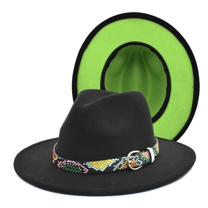 Detail of two-tone fedora hat with green interior and snakeskin band with gold buckle