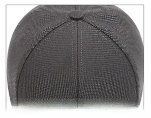 Detail of meticulous stitching and button on the top crown of the grey baseball cap