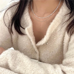 Close-up of double layer S925 sterling silver beaded chain necklace on a model