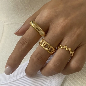 Three-piece gold-tone stainless steel ring set featuring smooth, chain, and beaded styles