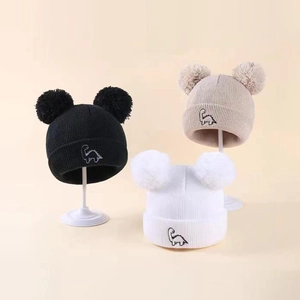 Kids knitted beanie hats with dual pom-poms and cute dinosaur embroidery in three colors