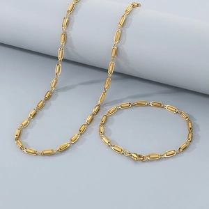 Elegant gold necklace and bracelet set with spiral textured oval chain links