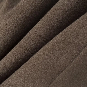 Close-up of deep brown wool fabric showing thick texture and premium material detail
