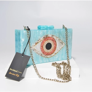 Blue marble acrylic evening bag with evil eye design and golden metal chain strap