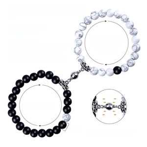 Detail of 8mm natural stone couple bracelets with magnetic heart charm and size guide