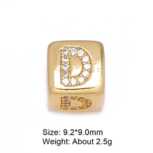 Macro shot of 8mm gold letter D charm bead with inlaid white zircon for DIY jewelry