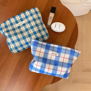 Detail of floral and checkered fabric cosmetic bags with Simple Wish woven labels