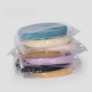 Detail view of knitted beret hats individually packed in clear zip bags