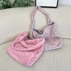 Detailed view of leopard print plush tote bags in pink and purple with checkered lining