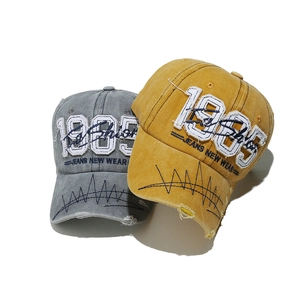 Vintage washed baseball cap with 1985 embroidery and distressed brim in grey and yellow