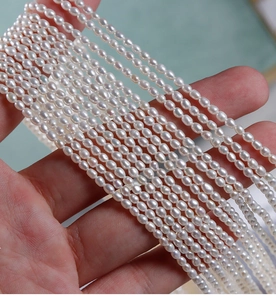 Detailed view of high luster 2.5mm natural white oval freshwater pearl beads for DIY jewelry