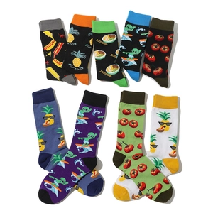 Detail view of cotton crew socks featuring colorful tomato and creative fruit patterns