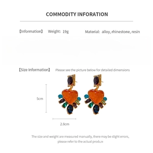 Detailed dimensions of vintage resin heart earrings with colorful rhinestones and size labels
