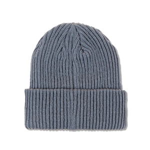 Detailed close-up of ribbed knit texture on a blue-grey winter beanie with fold-over cuff