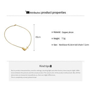 Detail of whale pendant necklace in matte gold finish with zircon inlay and dimensions