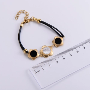 Detail view of 18k gold plated plum blossom bracelet with ruler showing size measurement