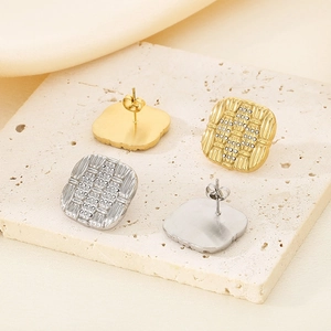 Detail view of square woven earrings in 18K gold and silver finishes with crystals
