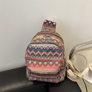 Ethnic bohemian woven backpack with colorful geometric patterns and silver zippers