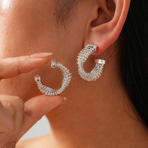 24k gold plated twisted C-shape hoop earrings with sterling silver needle on ear