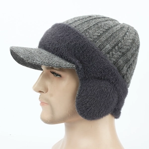 Detail view of winter knitted cap featuring plush fleece lining and ear flaps for warmth