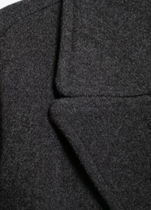 Detail of dark gray wool blend coat showing fine fabric texture and neat stitching