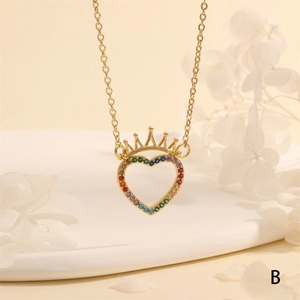 Detail of a gold heart crown pendant featuring vibrant rainbow cubic zirconia inlay