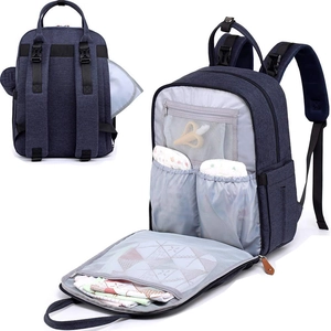 Detailed interior of a deep blue nursing backpack with wide mesh storage and padded straps