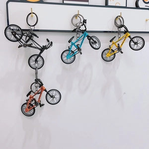 Miniature mountain bike keychain set in four vibrant colors with movable wheels and hooks