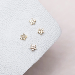 Macro shot of 18K gold plated flower earrings with sparkling cubic zirconia inlay